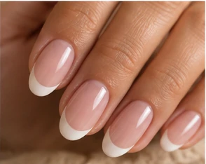 Almond nails with a sheer pink base and crisp white French tips
